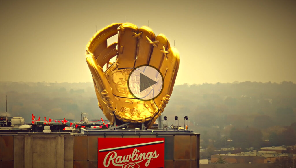 Gold glove on top of a gold tower.